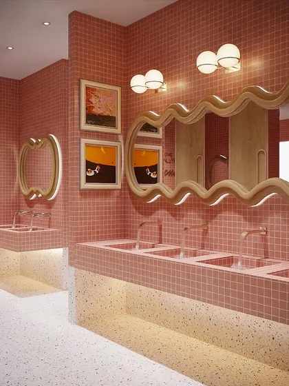 A rendering of the women's washroom, designed to be a showstopper. The space features custom-tiled sinks, playful wavy mirrors, and warm, flattering lighting.