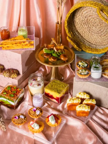 An abundant modern Indian festive spread designed to make you the host of the season. This arrangement features a variety of my signature items, including layered desserts, savory tarts, and fresh dips, all presented beautifully.