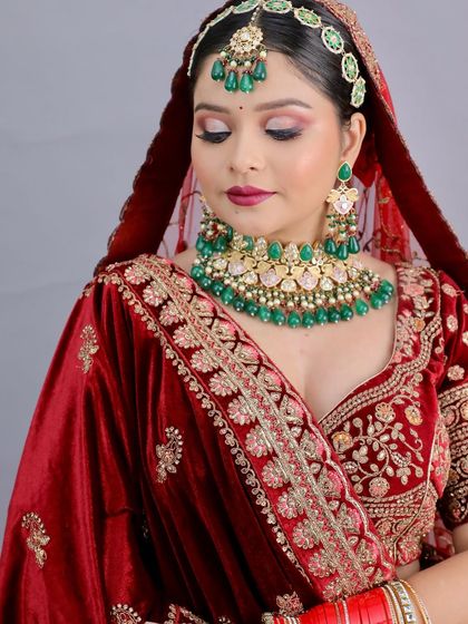 A close-up of the student's work, highlighting the intricate eye makeup and rich lip color. The technical skill is evident.