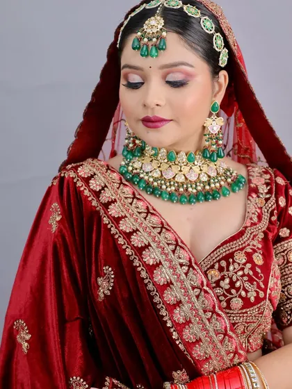 A close-up of the student's work, highlighting the intricate eye makeup and rich lip color. The technical skill is evident.