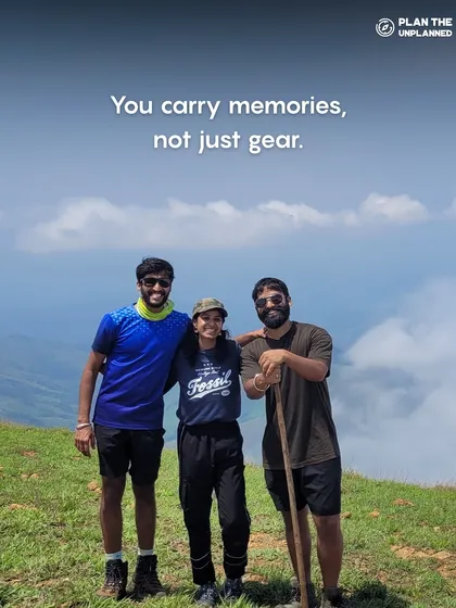 Three friends on a mountain top. This image perfectly illustrates that on our trips, you carry memories, not just gear.