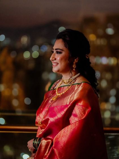 Another beautiful portrait against the bokeh of city lights. Her smile and radiant makeup truly shine.