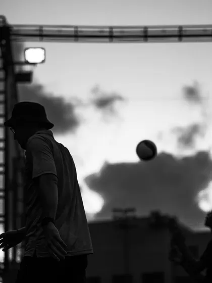 The ball in flight after a serve, a simple yet evocative black and white image.