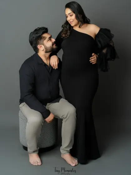 A look of love and admiration. This candid-style portrait captures a genuine moment of connection between the expecting parents.