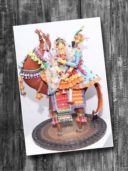 A magnificent 3D paper quilling artwork of a traditionally adorned Rajasthani couple on a camel. Our classes cover both basic and advanced quilling.