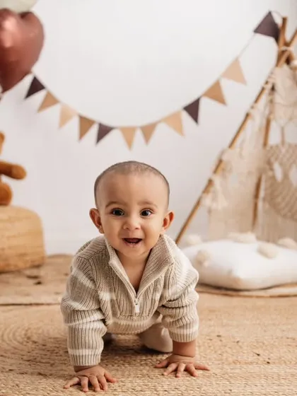 The first birthday is such a huge milestone! This little one was so excited to crawl and explore my boho-themed setup, complete with a mini teepee and "One" sign. These sessions are all about capturing their budding personality.