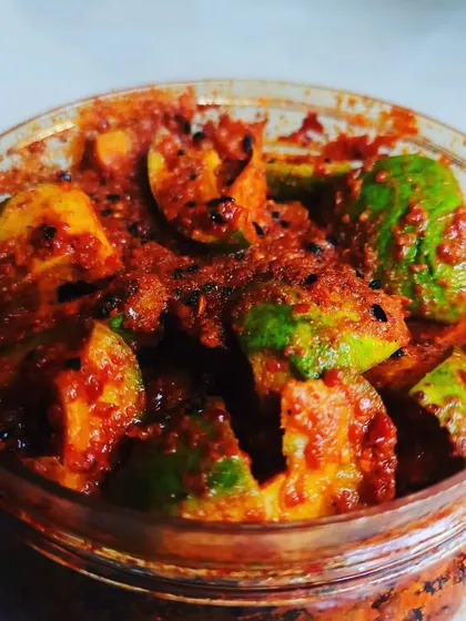 My tangy mango pickle, with visible seeds like kalonji (nigella seeds) mixed in for that authentic Punjabi flavour.