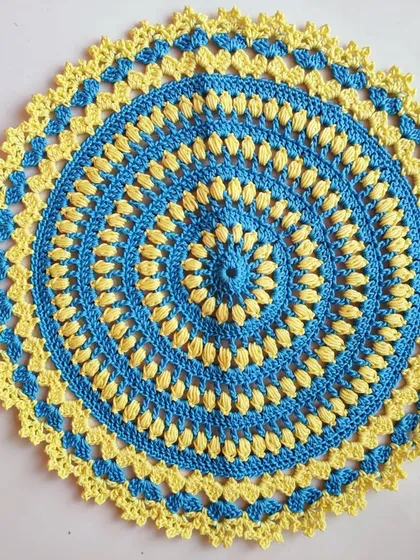 This blue and yellow doily is another example of a beautiful home decor item. The alternating puff stitches create a lovely texture and visual interest.