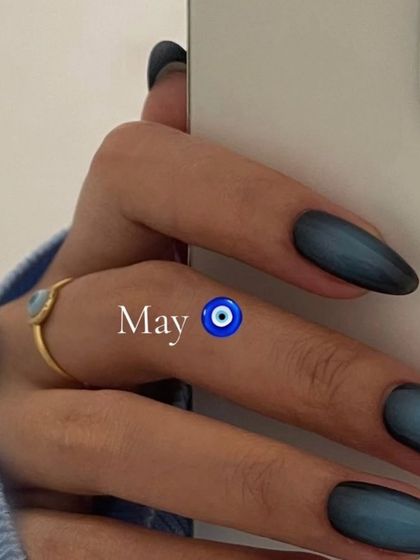 Aura nails are so trendy. This one features a deep blue aura, perfect for a "May" vibe with an evil eye.