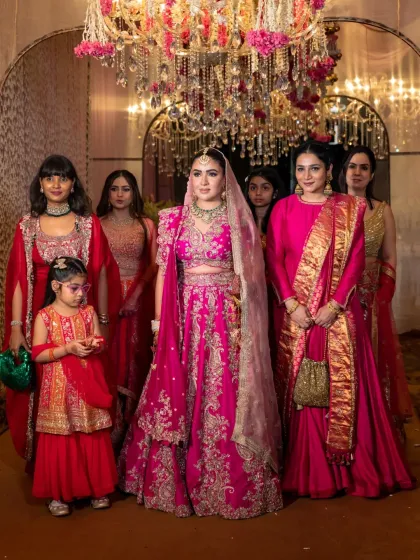 The bride surrounded by her bridesmaids and family. This group portrait captures the vibrant colors of the outfits and the strong bond between the women.