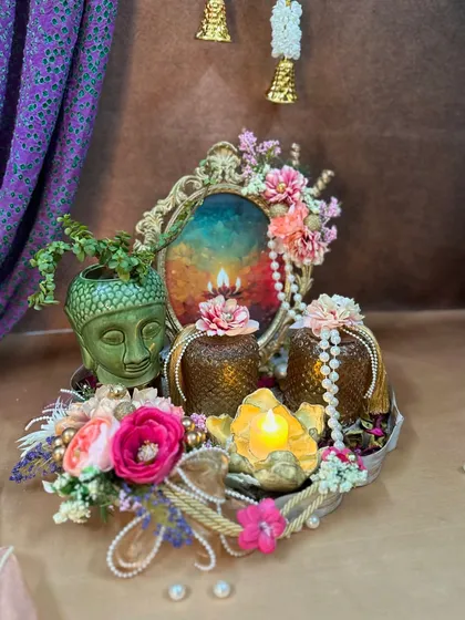 Another view of the serene Buddha hamper, showcasing the intricate details of the vintage frame and the pearl strings adorning the jars.
