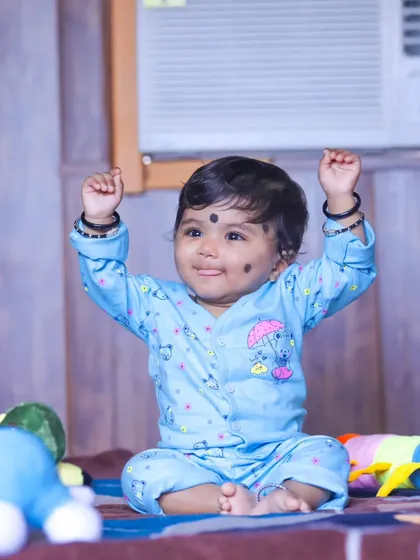 An indoor pre-birthday photoshoot for a baby. Even simple setups at home with favorite toys can create adorable and memorable portraits.