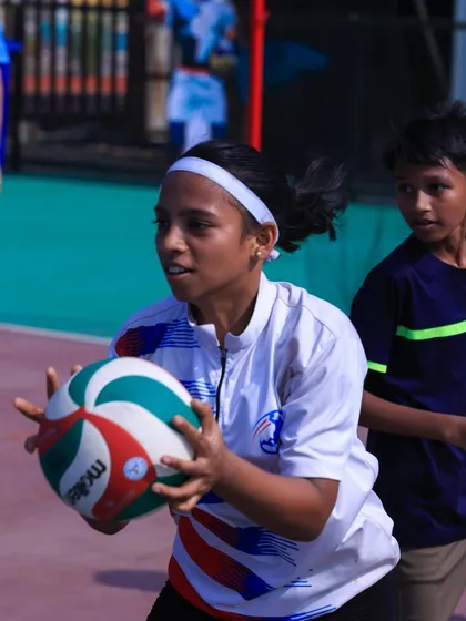 A young athlete at our camp, focused on setting the ball. We welcome players of all ages and skill levels.