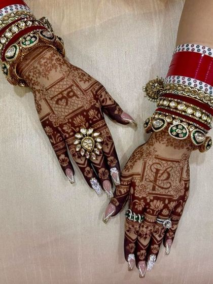 A lovely Karwa Chauth design featuring the initials 'Om' and 'L' on the palms, surrounded by lotus patterns.