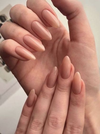 A classic nude manicure on elegant, almond-shaped nails. This is a go-to look that is always in style.