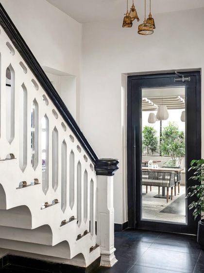 When working with a heritage property, I honor its history. I restored this original staircase, accenting the intricate handrail with a bold black finish and adding patterned tiles to the risers, celebrating the building's soul while giving it a new life.