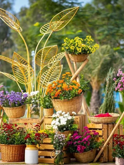 A beautiful floral installation at the entrance, featuring flowers in wicker baskets and modern gold leaf sculptures.