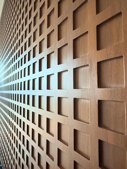 A close-up of the custom CNC cut wood panel in our serene bedroom project. The repeating geometric pattern adds a layer of intricate detail and texture that elevates the entire space. It’s these details that transform a simple room into a work of art.