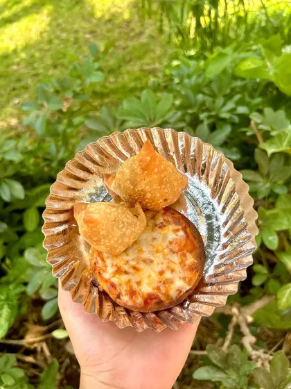 A plate of mini samosas and cheesy pizza bites, the perfect fusion snacks for a modern Holi party. I offer a mix of traditional and contemporary dishes.