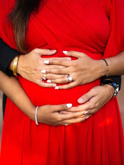 Sometimes, the most powerful images are in the details. This close-up of both parents' hands cradling the baby bump is an iconic maternity shot. It symbolizes connection, protection, and the shared anticipation of welcoming a new life.