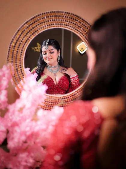 A creative mirror shot, adding depth and a different perspective to the bridal portrait session.