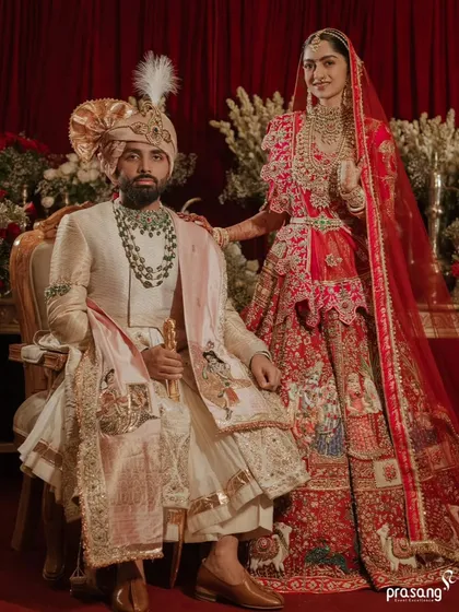 A wedding portrait is a legacy. I work with the finest photographers to stage and capture regal moments like this, ensuring the couple's attire, the opulent floral backdrop, and the overall composition reflect a story of timeless elegance.