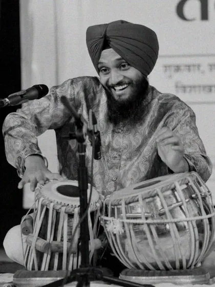 A black and white photograph from a live performance, capturing the joy I feel when I connect with the audience through the bols of the tabla.