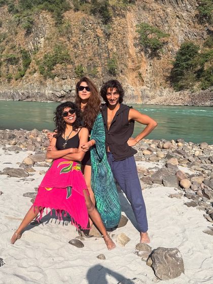 Posing with friends on the sandy beach of the Ganga. These moments of fun and connection by the sacred river are core memories from our retreats.