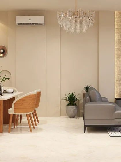 This wider shot shows the dining area as part of an open-plan living space. The grand crystal chandelier above the living area adds a touch of glamour that complements the simple elegance of the dining setup.