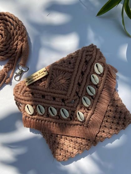 Our shell bag in this beautiful brown color gives a perfect boho look. The detachable strap is intricately knotted, and we ship these worldwide.