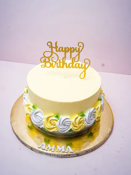 A simple and elegant birthday cake for "Amma". The clean design with a border of yellow and white roses is a classic and heartfelt way to celebrate your mom.