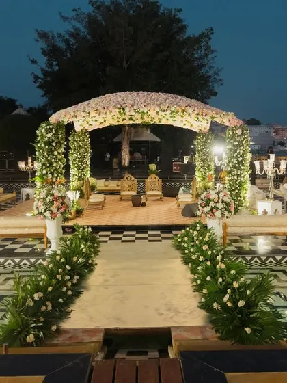 I transform royal palace courtyards into dreamlike wedding venues. This stunning floral mandap at The Leela Palace Udaipur, set against the water, showcases my ability to blend natural beauty with opulent design for a destination wedding.