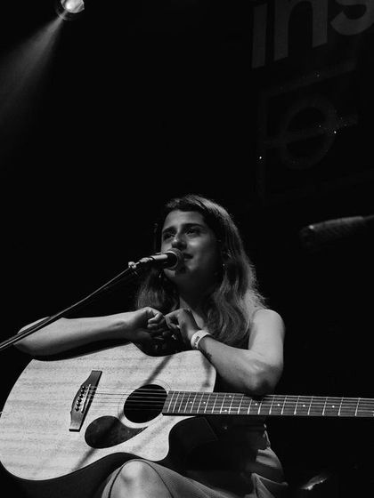 Resting my guitar between songs during a duo gig. A quiet moment in an energetic set.