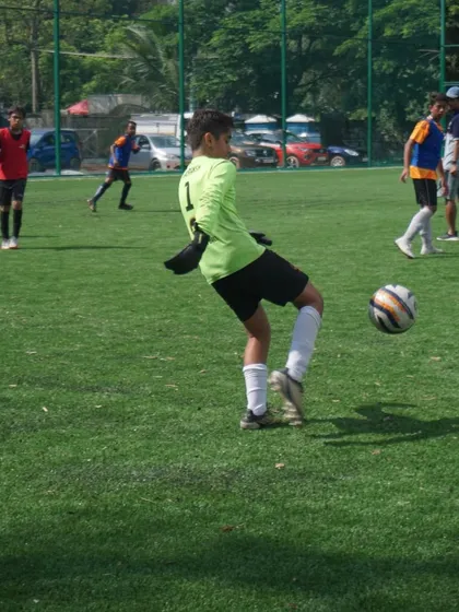 A young keeper practices his distribution with a powerful kick during trials. We train our goalkeepers not just to stop shots, but to be the first point of attack with accurate long balls and throws.
