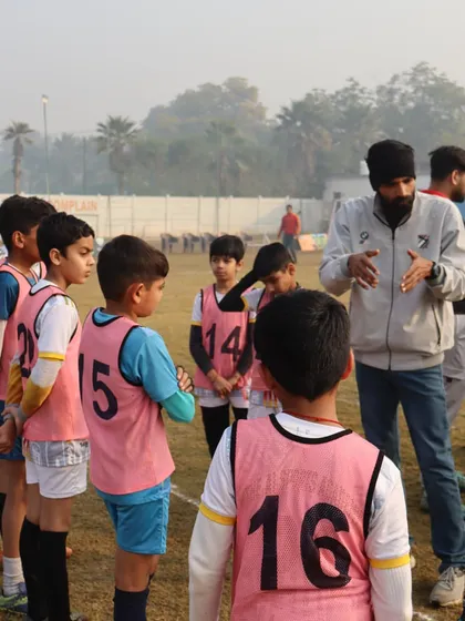 A coach gives tactical instructions to the team during a timeout in the HCL Future Stars Grassroots League.