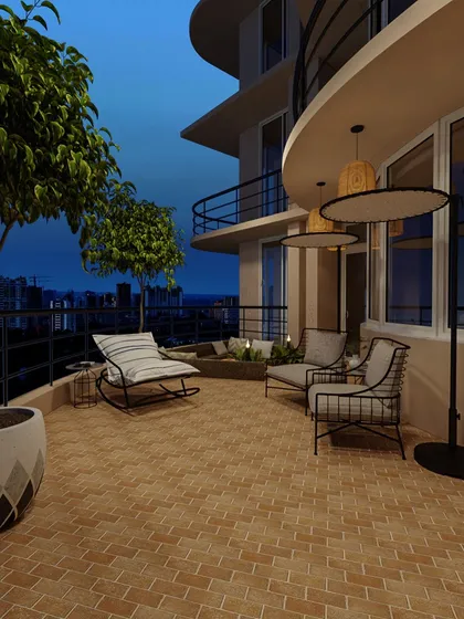 As evening approaches, the balcony transforms into a magical space with ambient lighting, offering a beautiful view of the city skyline at dusk.
