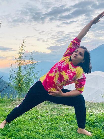 Parshwakonasana (Side Angle Pose) is fantastic for stretching the sides of the body and strengthening the legs. This photo captures the pose against a beautiful mountain backdrop.