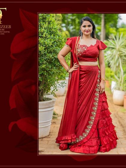 A full look at our beautiful red draped saree, perfect for Karwa Chauth or any festive occasion. The ruffled details and embellished blouse make it a truly special outfit.