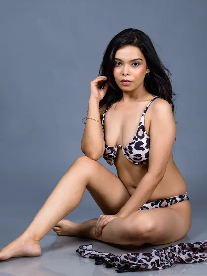 A relaxed portrait of a model in an animal print bikini. This shot is perfect for swimwear lookbooks or a model's commercial portfolio.