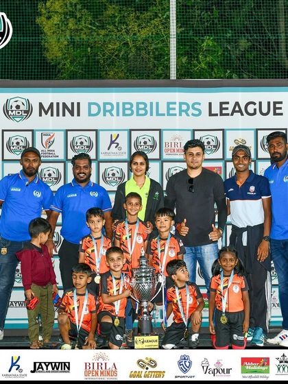 The team behind the team. Our U7 champions pose with their coaches and the MDL trophy, a moment that celebrates the collective effort of players, staff, and parents.