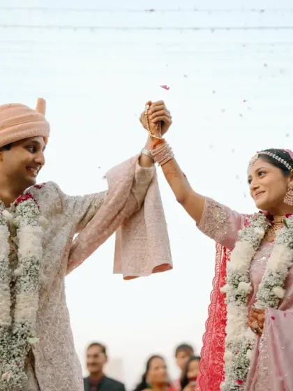 A joyful moment during the varmala ceremony. The couple is framed by the decor, showcasing how the design becomes the backdrop for the most cherished memories of the day.