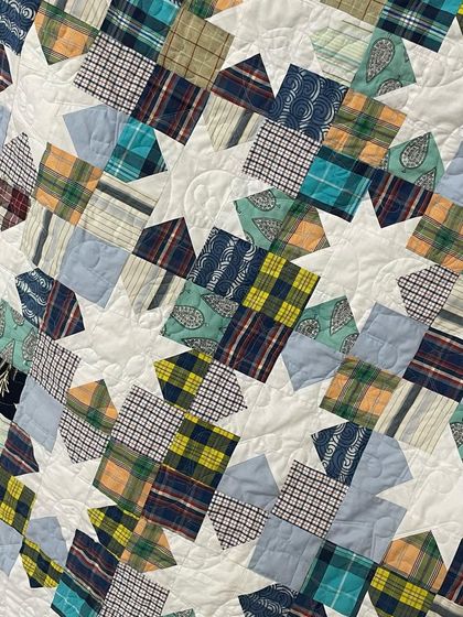 A memory quilt made from 15 of a client's husband's shirts, arranged in a beautiful Sawtooth Star pattern.