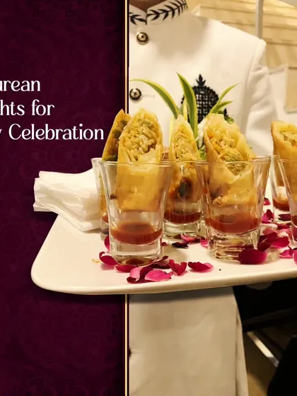 A server in an elegant uniform presents our epicurean delights. These crispy spring rolls, served in shot glasses with dipping sauce, are designed for easy enjoyment at any celebration.