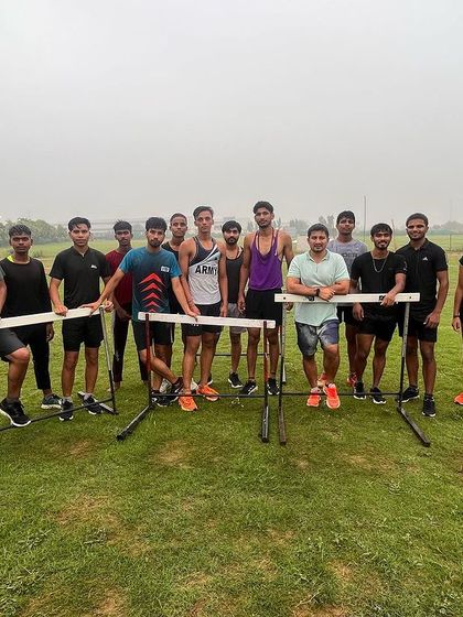 The team poses with hurdles after a tough training session. We are a family built on shared effort and a common goal.