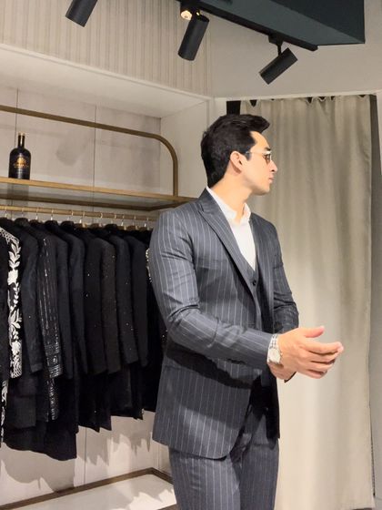 A side profile of a charcoal grey pinstripe three-piece suit. The waistcoat adds a layer of formality and sophistication, perfect for important meetings or corporate events.