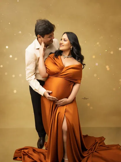 An intimate and glamorous couple's portrait. The husband's gentle touch and the soft, sparkling lights create a romantic atmosphere, highlighting the couple's deep connection.