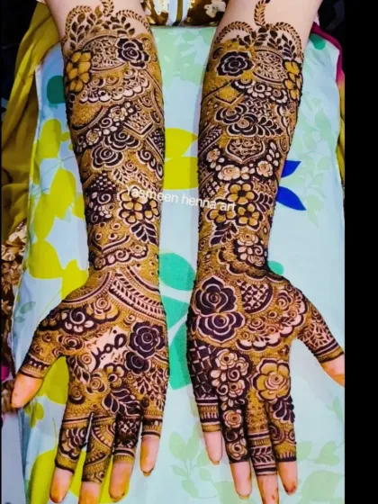 A lovely floral bridal design with the groom's name, Sabr, written on the palm.