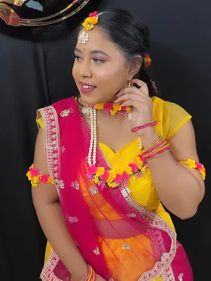 A confident pose from the Haldi-ready model, her makeup looking fresh and bright.