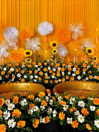 A close-up of our sunflower-themed Haldi decor, showing the rich texture and color of the fresh flowers surrounding the ceremonial brass pots.