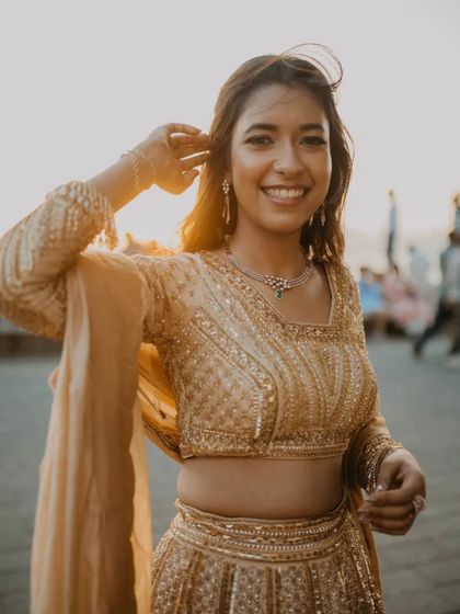 A beautiful, happy portrait of the bride-to-be at Marine Drive during golden hour. Her radiant smile and the wind in her hair capture a moment of pure joy.